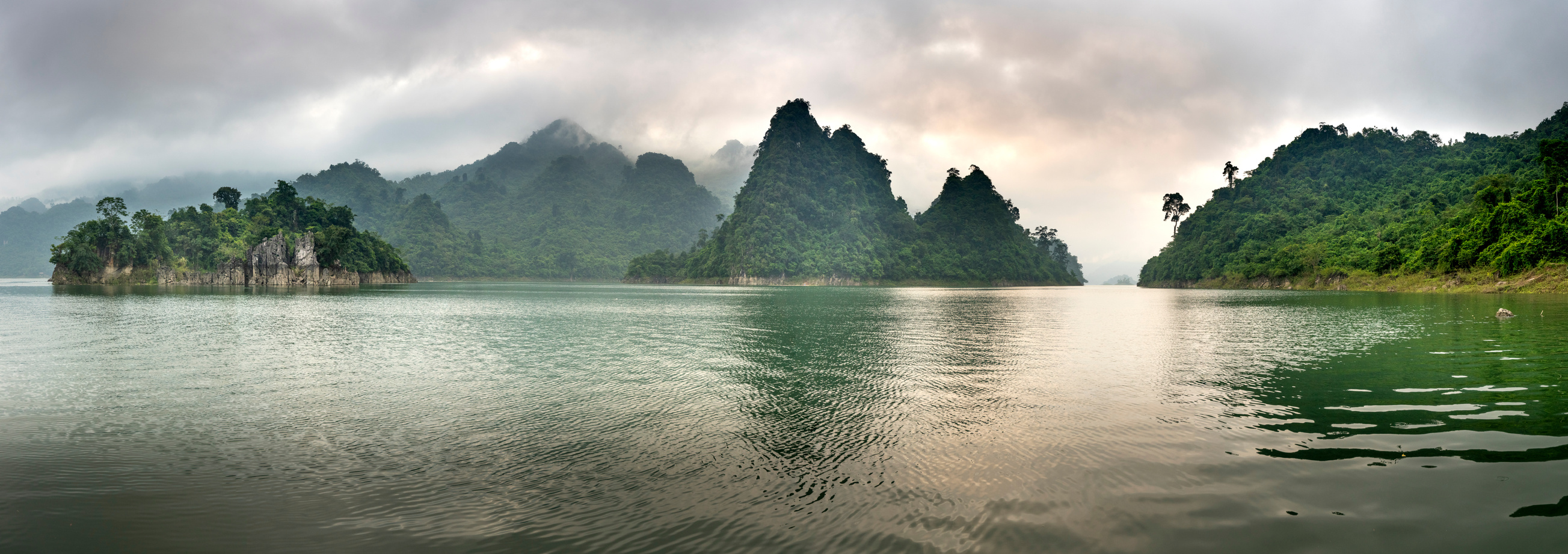 Rippling lake surrounded by hills covered with jungles